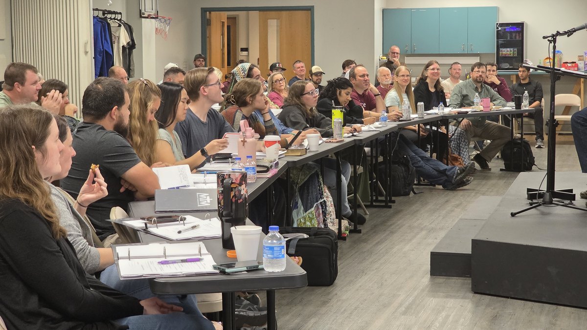 Students at the long tables during an MTM Module 1 session